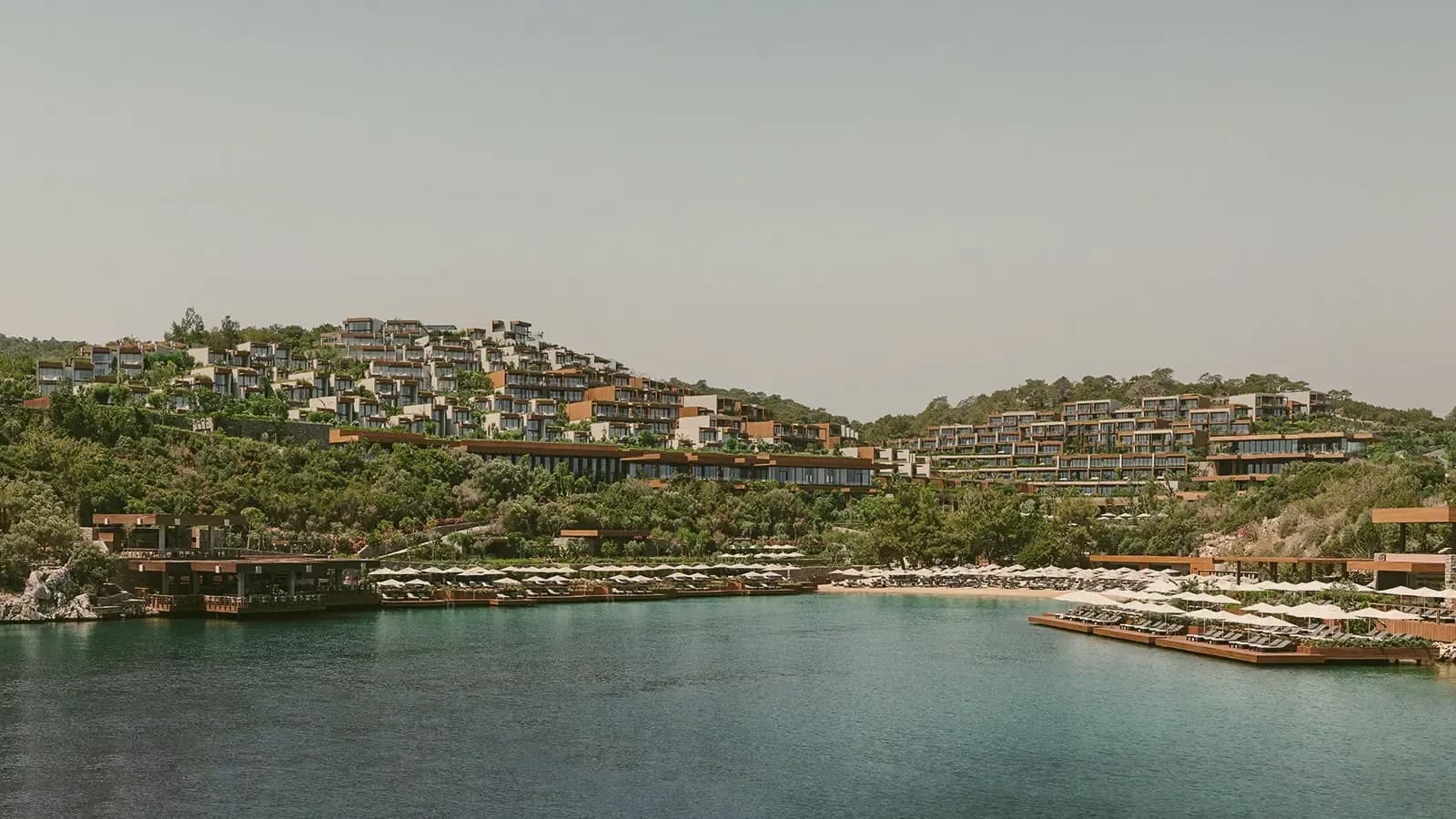 The group's terraced resort above its bay